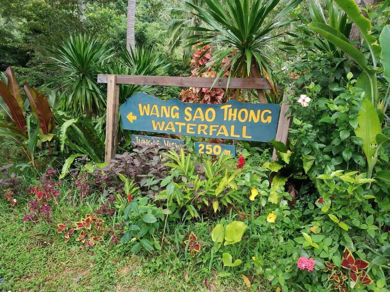 Boulders and jungle framing Wang Sao Thong Waterfall's lower tier