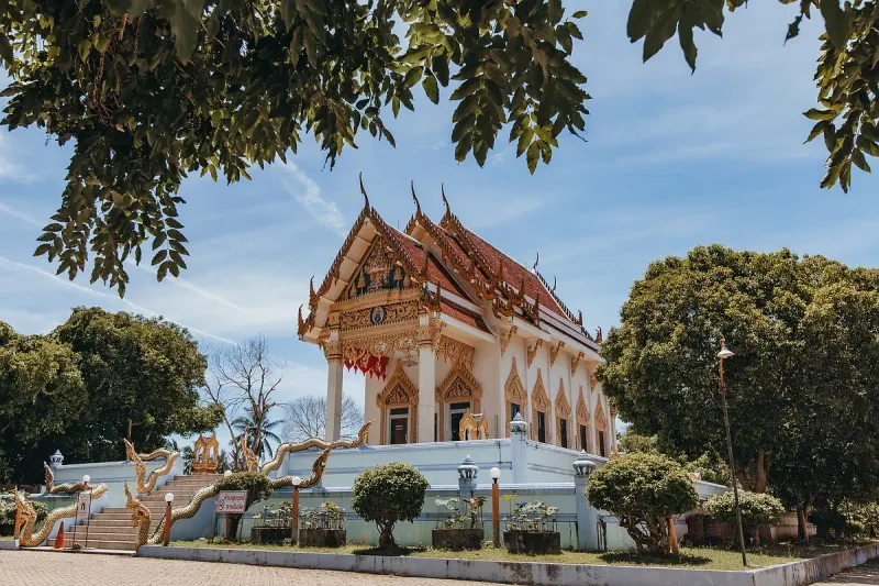 Wat Khunaram's ordination hall with naga-flanked staircase and tiered red roof