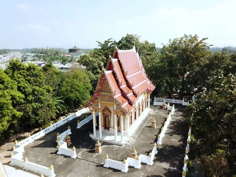 Aerial view of the temple hall's tiered red roof surrounded by trees