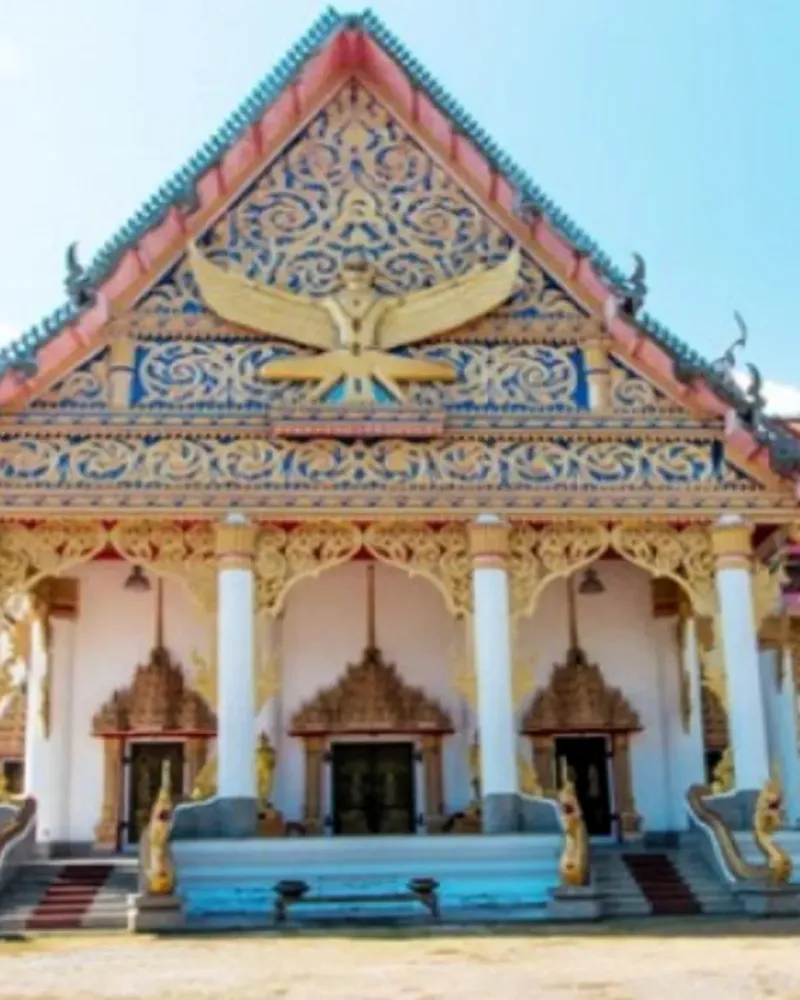 Ornate temple gable carved with a garuda figure above the entrance columns