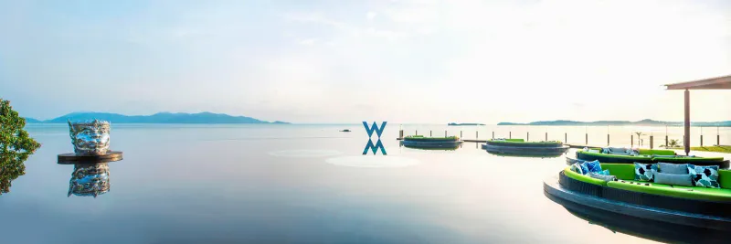 WOOBAR's infinity pool at W Koh Samui with round daybed platforms and a calm view over the Gulf of Thailand